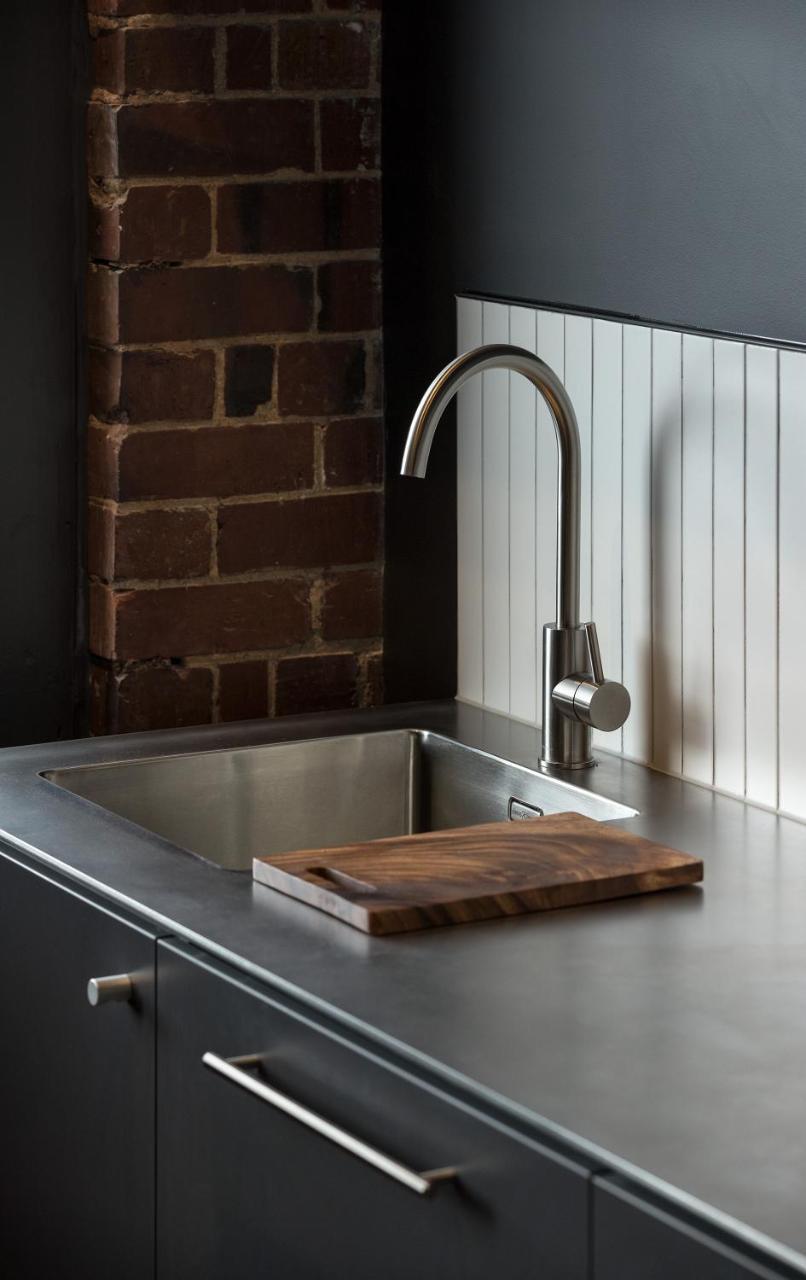 The Chamberson 호텔 더니든 외부 사진 A kitchen sink with a wooden cutting board